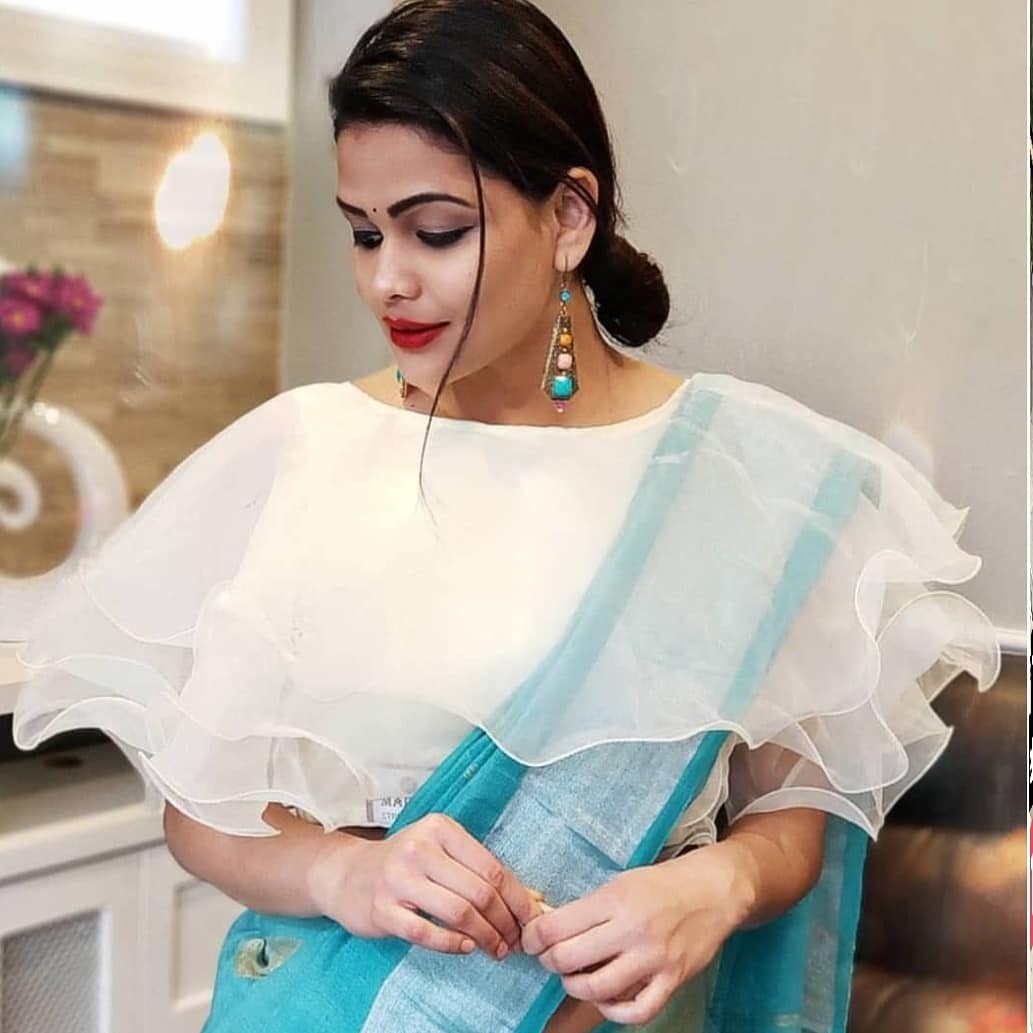 Gorgeous actress and anchor Lasya Manjunath wearing net ruffle saree.  Outfit : Khyathi design studio. Styling : Kruthi